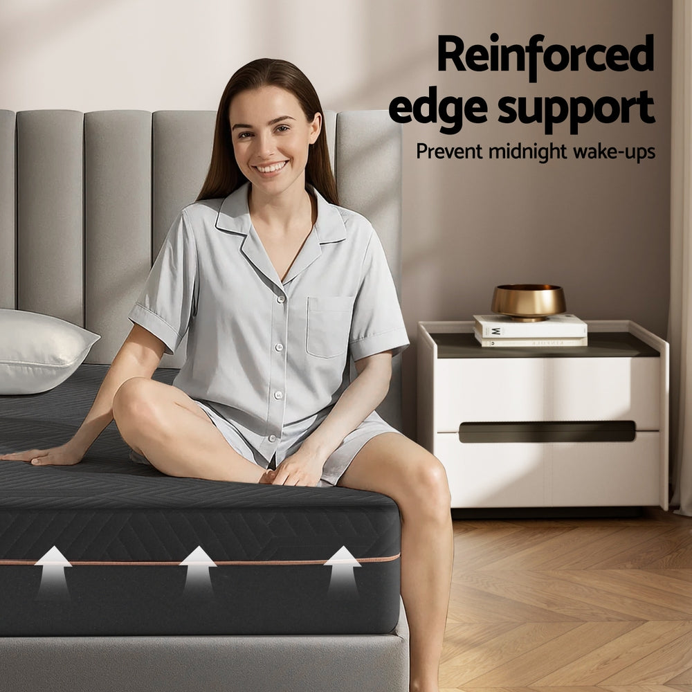 Woman sitting on a bed with reinforced edge support feature highlighted