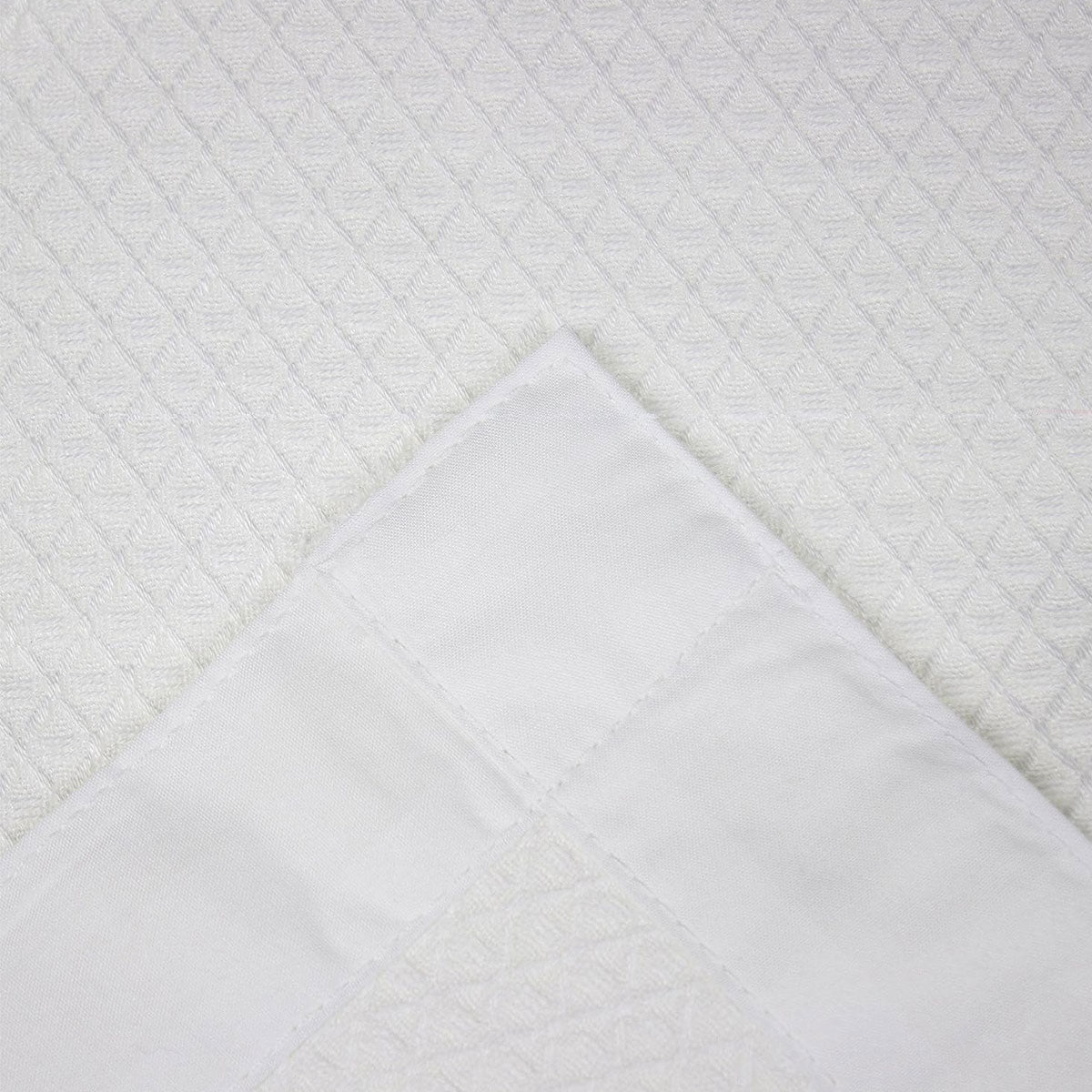 Close-up of textured white fabric with a diamond pattern - Dust Mite Allergy Solutions