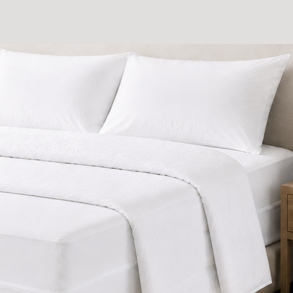 White dust mite pillow protectors, doona protector and zippered mattress encasement on a made bed