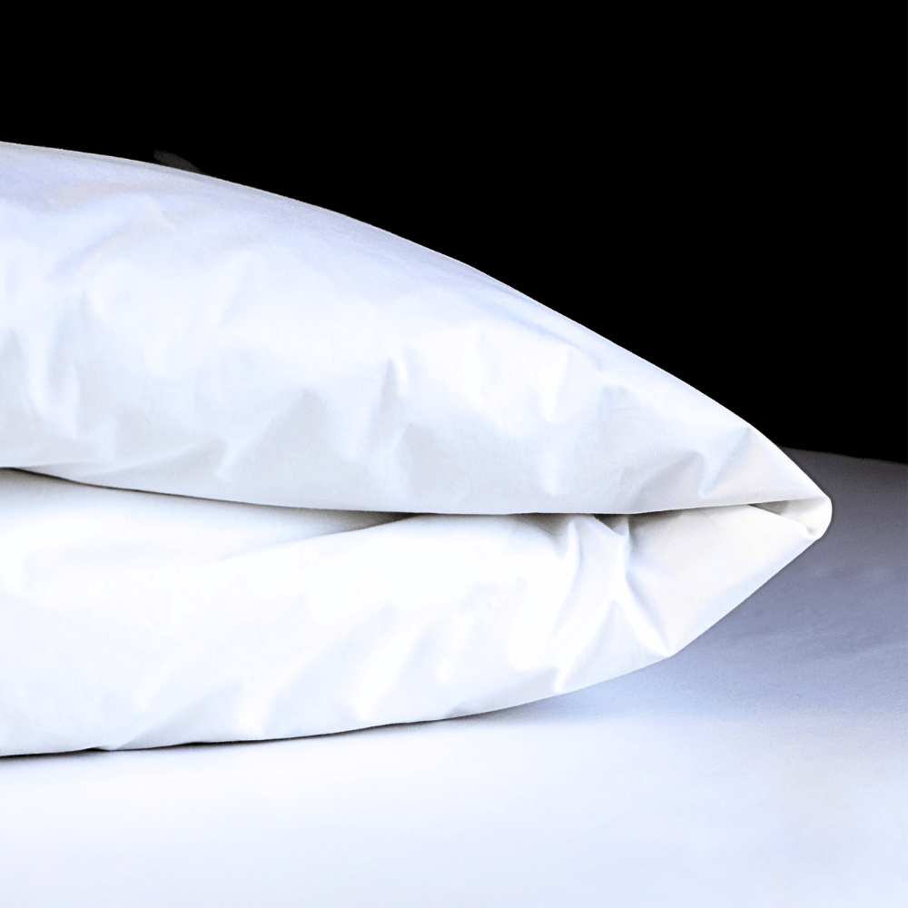 White dust mite duvet protector on a white surface with a black background