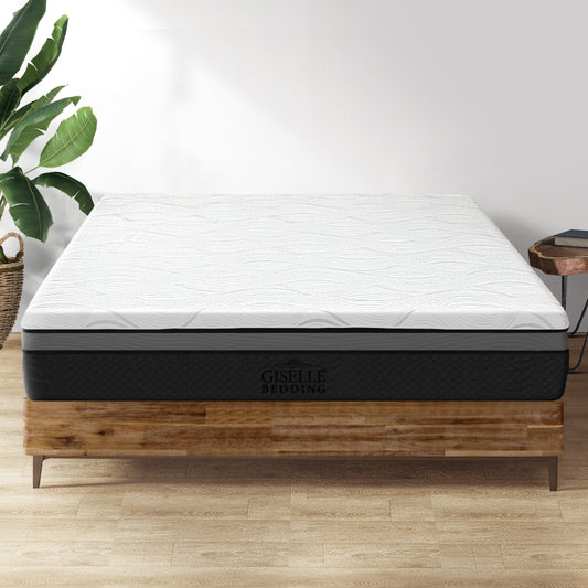 Mattress on a wooden bed frame with a plant in the background