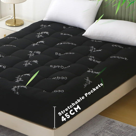 Black mattress pad with bamboo text on a bed in a bedroom setting
