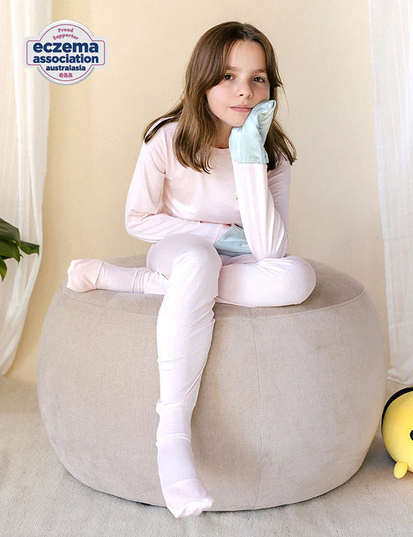 Girl in a pink eczema-friendly organic bamboo long-sleeve pyjama set 