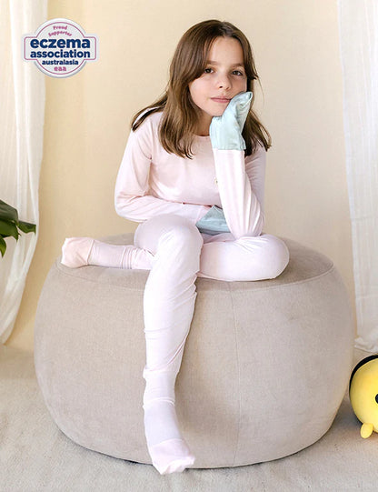 Girl in a pink eczema-friendly organic bamboo long-sleeve pyjama set 