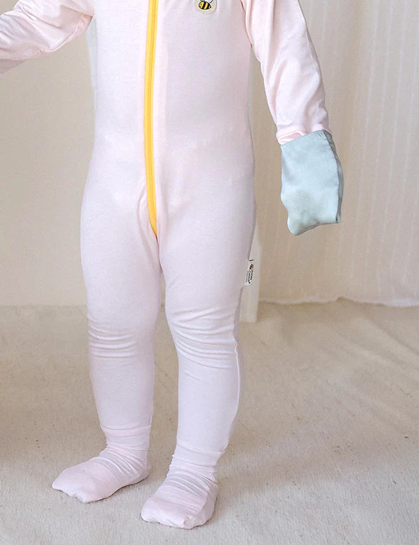 Close-up of mulberry silk mittens on a Honey & Stitch organic bamboo baby onesie