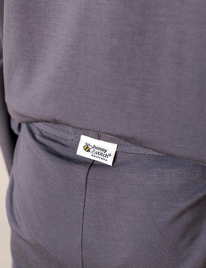Close-up of the side pocket and tag-free Honey & Stitch label on dark gray organic bamboo shorts