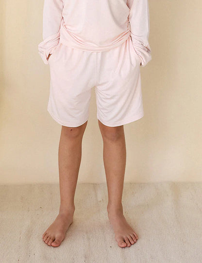 Front view of pink organic bamboo kids' shorts with side pockets — eczema-friendly by Honey & Stitch