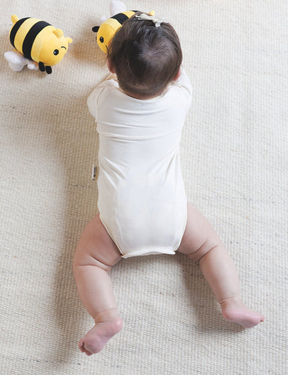 Baby bodysuit in soft organic bamboo with a quiet hook-and-loop closure