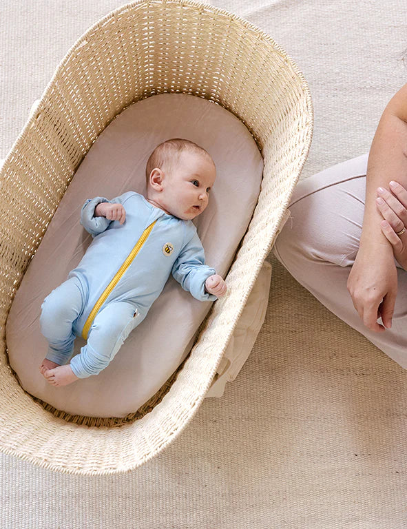 Baby wearing a soft organic bamboo eczema-friendly onesie in blue