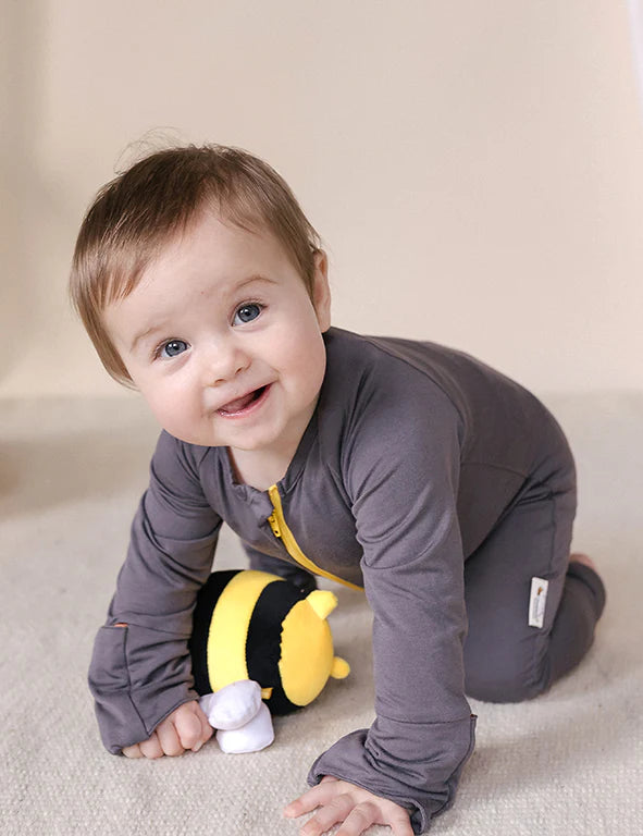Baby wearing a soft organic bamboo eczema-friendly onesie in dark gray