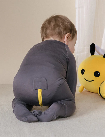 Hidden 3-way zipper and tag-free neckline on an eczema-friendly bamboo onesie